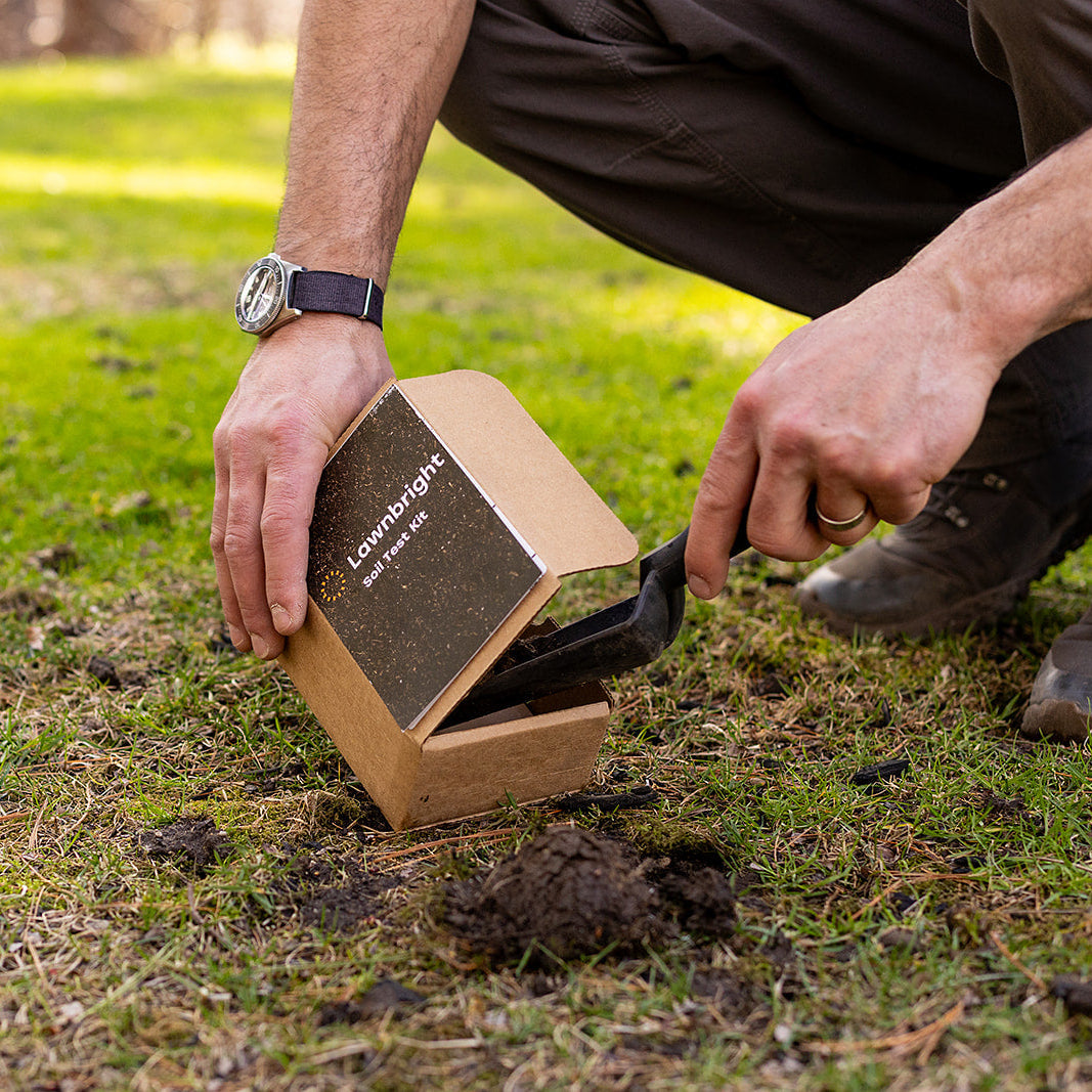 A man scoops soil into a soil test kit.