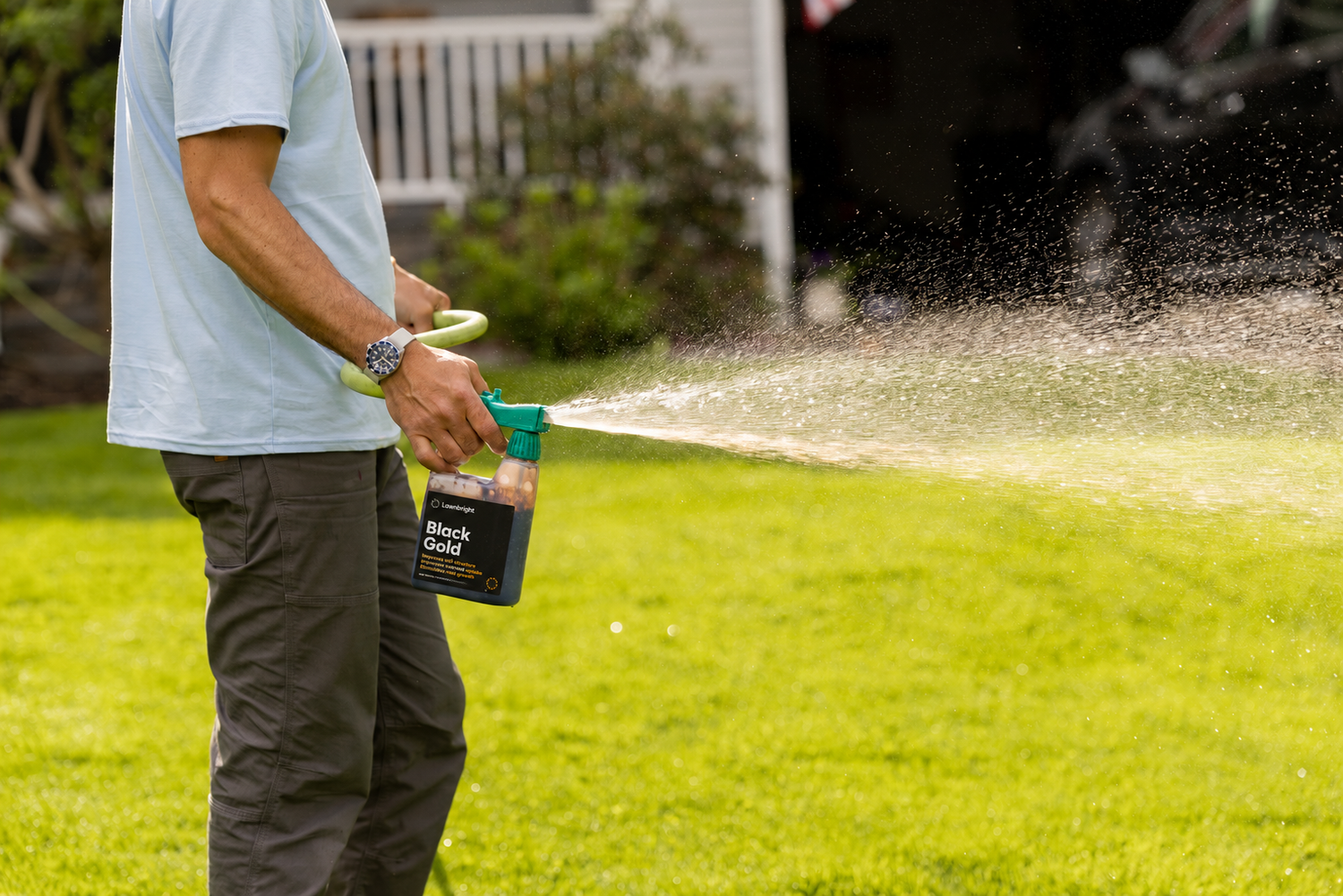 Person using a lawn care product on a grassy area