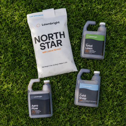 A bag of Lawnbright North Star fertilizer and two bottles of Lawnbright lawn care products arranged on green grass. The products include North Star with Lateral Spread, Aero Flow, and Cold Snap.