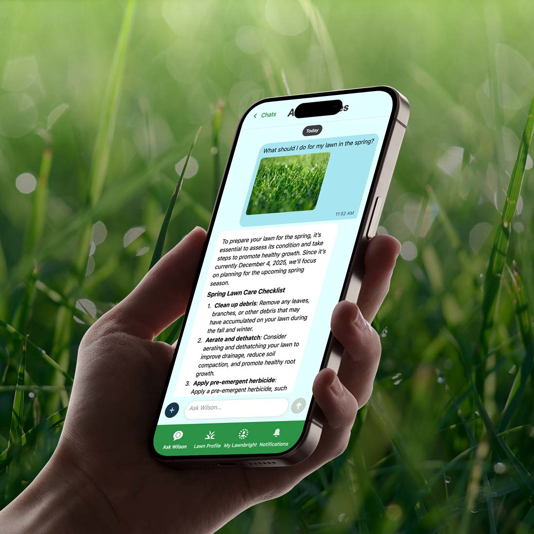 Hand holding a smartphone with an app on a grassy background